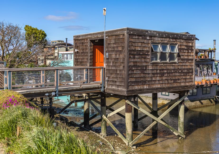 The bright, sunny exterior of a modern luxury coastal home, representing the high-value local real estate market that top agents compete for.