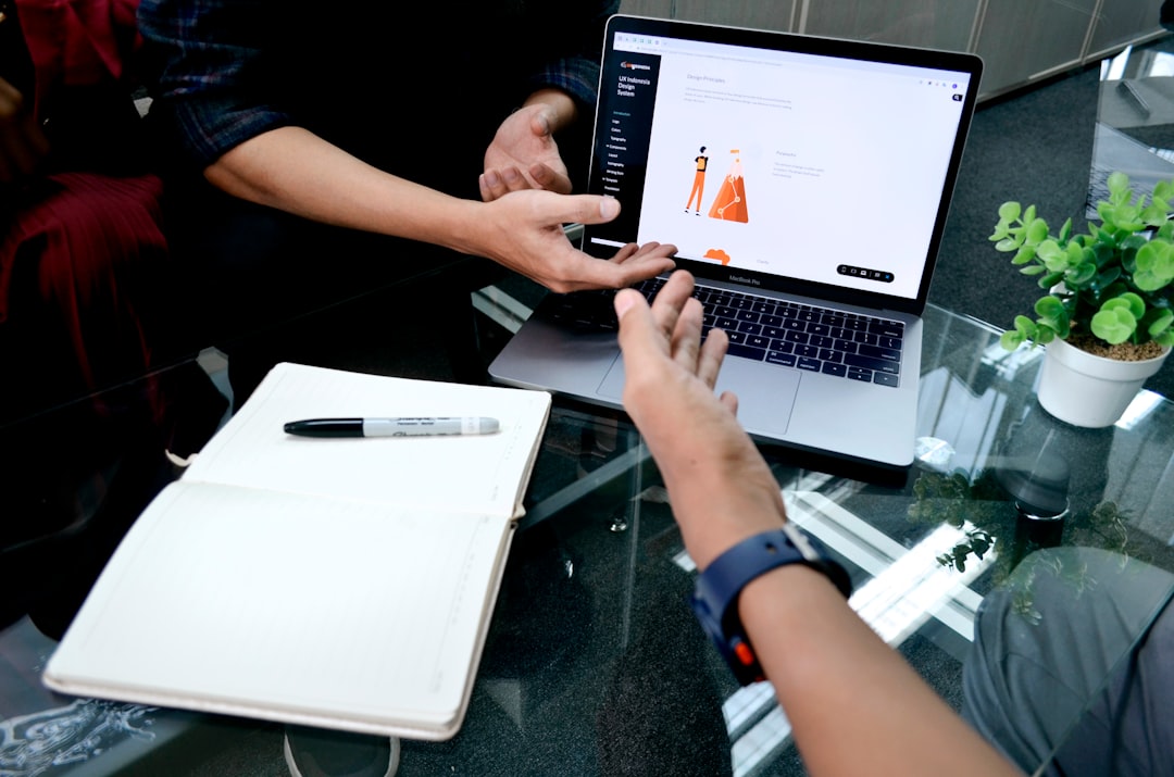 A real estate agent in a modern office, focused on analyzing data on a laptop screen, illustrating the use of advanced digital marketing and SEO.